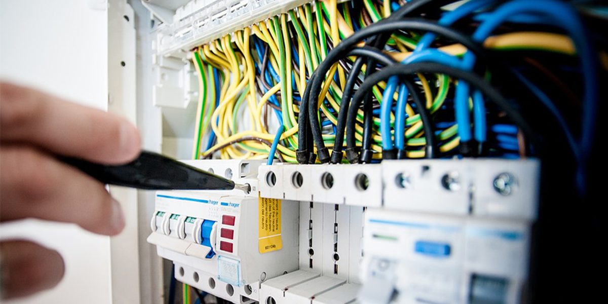 Hands terminating conductors in a consumer unit
