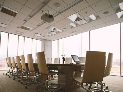 Office meeting room with ceiling lighting and a projector